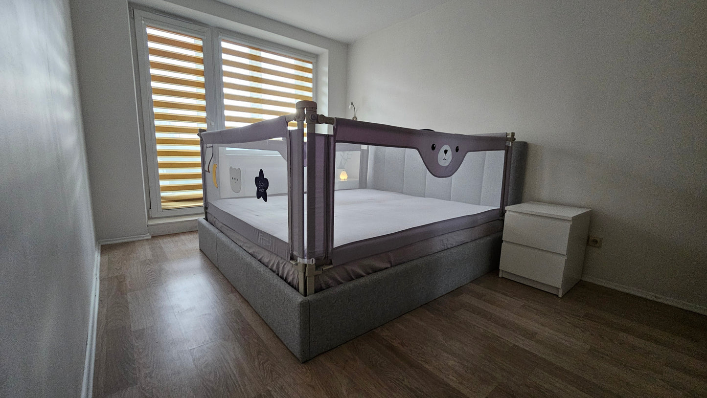 Modern nursery with large baby bed, safety rails, wooden floor, and window blinds